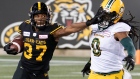 Frankie Williams stiff-arms Don Unamba