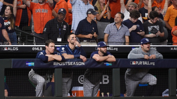Tampa Bay Rays players watch as the Houston Astros celebrate 