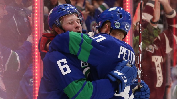 Brock Boeser (6) celebrates his goal with teammate Elias Pettersson, The Canucks Brock Boeser (6) celebrates his goal with teammate Elias Pettersson