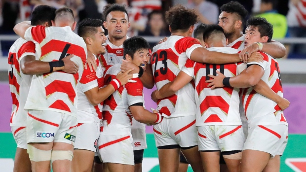 Japan rugby players celebrate, The Canadian Press Japan rugby players celebrate