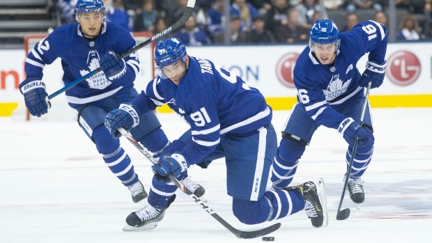 Leafs captain John Tavares is flanked by Trevor Moore and Mitch Marner Tuesday.