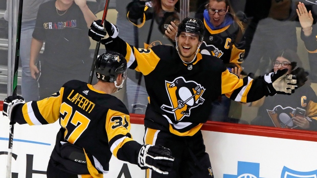 Brandon Tanev (13) celebrates his overtime goal with Sam Lafferty 