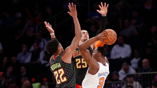 RJ Barrett (9) looks to pass with Atlanta Hawks forward Cam Reddish (22)