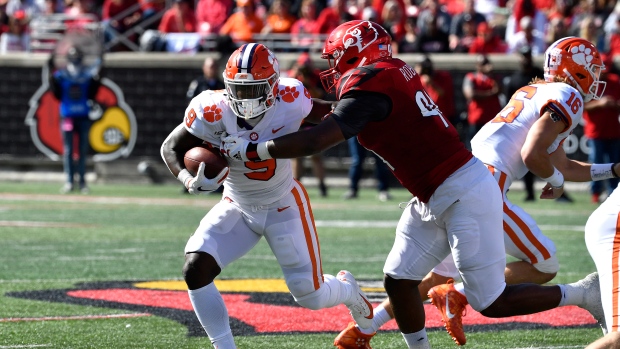 Travis Etienne (9) tries to get away from G.G. Robinson , The Canadian Press Travis Etienne (9) tries to get away from G.G. Robinson