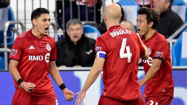 Marco Delgado (8) celebrates his goal with teammates Michael Bradley (4) and Tsubasa Endoh (31)