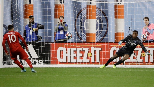 Alejandro Pozuelo converts a penalty kick on 'keeper Sean Johnson Wednesday in New York.