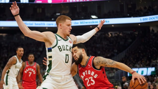 Toronto's Fred VanVleet runs into Milwaukee's Donte DiVincenzo on Saturday.