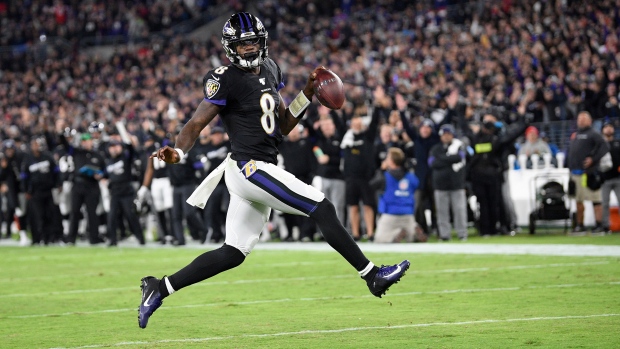 Ravens quarterback Lamar Jackson runs in a touchdown against the Patriots Sunday.
