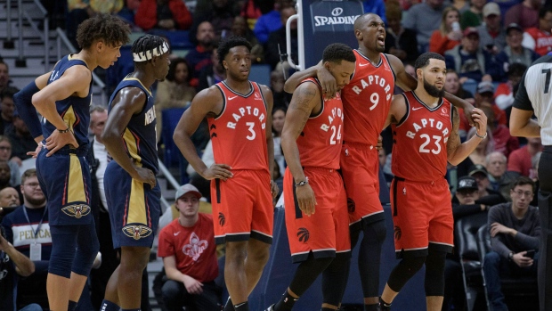 Serge Ibaka (9) is helped off the court by his Toronto Raptors teammates
