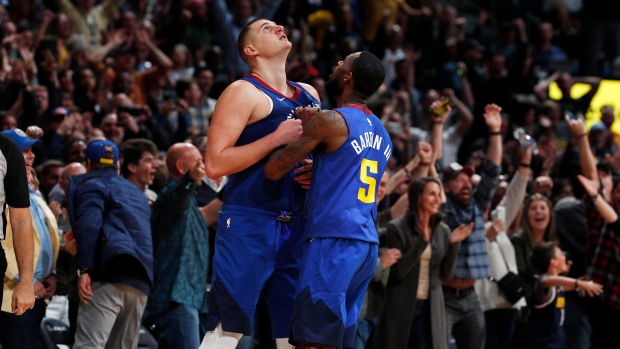 Nikola Jokic, left, is congratulated by guard Will Barton III