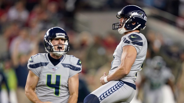 Jason Myers, right, celebrates with Michael Dickson