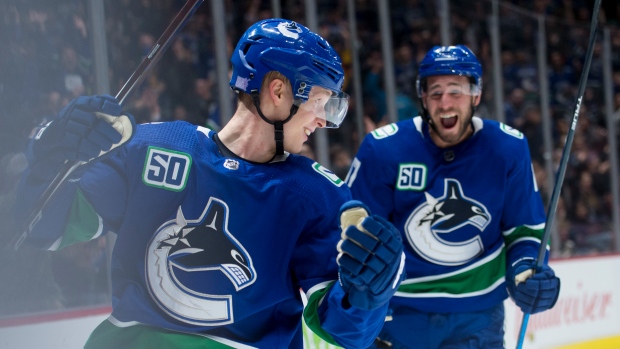 Elias Pettersson (40) celebrates with teammate Josh Leivo , The Canadian Press Elias Pettersson (40) celebrates with teammate Josh Leivo