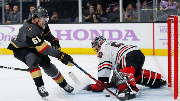 Corey Crawford (50) blocks a shot by Mark Stone (61)