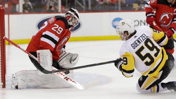 Mackenzie Blackwood (29) stops a shot by Pittsburgh Penguins' Jake Guentzel (59)