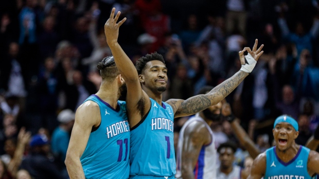 Malik Monk, center, celebrates with teammates Cody Martin, left, and Devonte' Graham