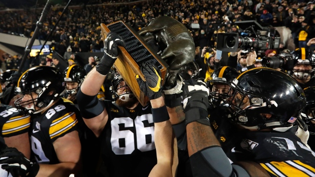Iowa carries off the Floyd of Rosedale Trophy , The Canadian Press Iowa carries off the Floyd of Rosedale Trophy