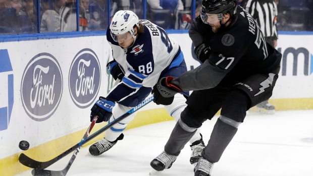 Jets defenceman Nathan Beaulieu battles Tampa Bay's Victor Hedman., The Canadian Press Jets defenceman Nathan Beaulieu battles Tampa Bay's Victor Hedman.