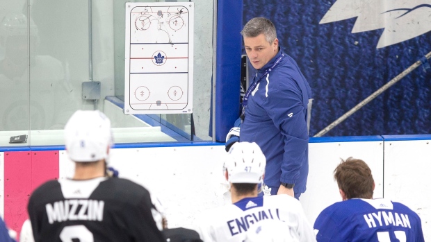 Leafs head coach Sheldon Keefe talks to his players during Monday's practice.