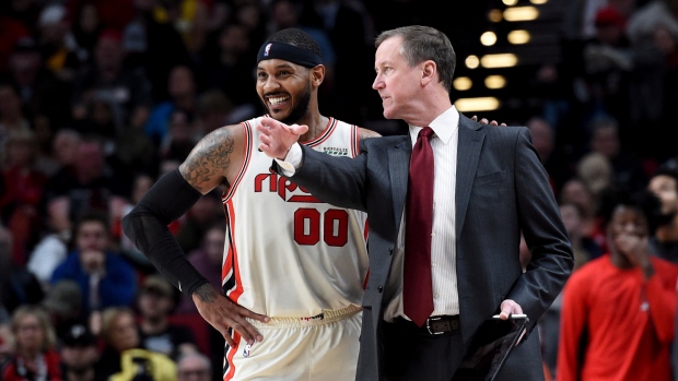 Carmelo Anthony, left, speaks with head coach Terry Stotts
