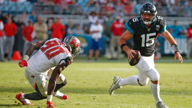 Gardner Minshew (15) scrambles away from Jason Pierre-Paul