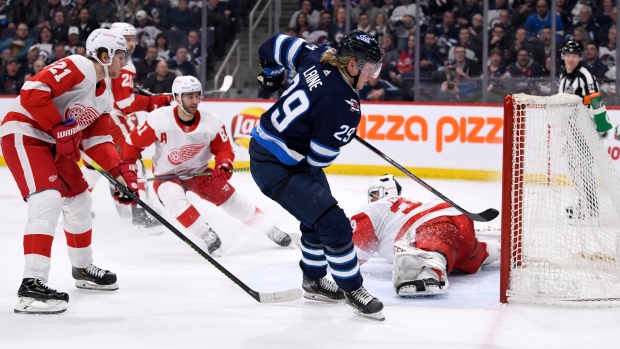 Laine scores on Comrie, The Canadian Press Laine scores on Comrie