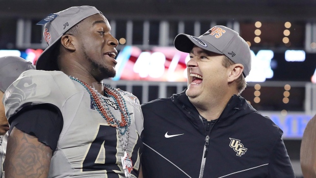 UCF linebacker Nate Evans, left, and coach Josh Heupel 