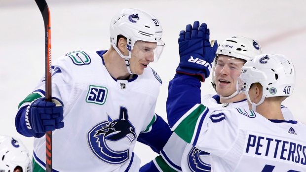  Tyler Myers celebrates with teammates 