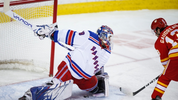 Henrik Lundqvist, left, lets in a goal from Johnny Gaudreau