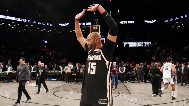 The New Jersey Nets player Vince Carter goes and hits a huge dunk