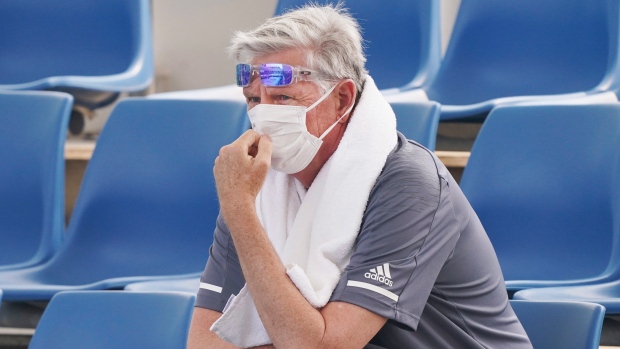 A spectator wears a mask as smoke haze shrouds Melbourne during an Australian Open practice