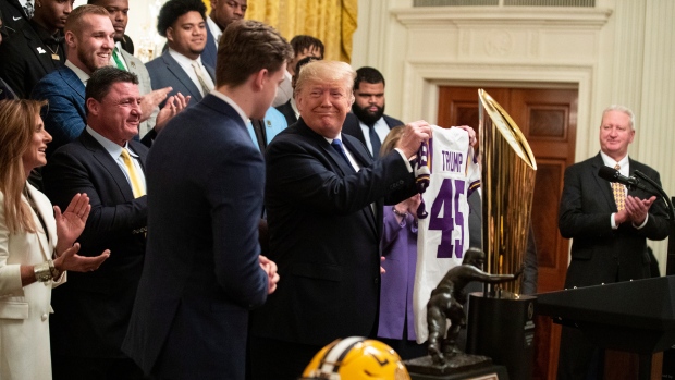 President Donald Trump smiles at quarterback Joe Burrow, The Canadian Press President Donald Trump smiles at quarterback Joe Burrow