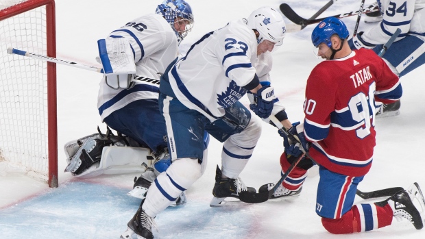 Leafs goalie Jack Campbell and defenceman Travis Dermott battle Montreal's Tomas Tatar on Saturday.