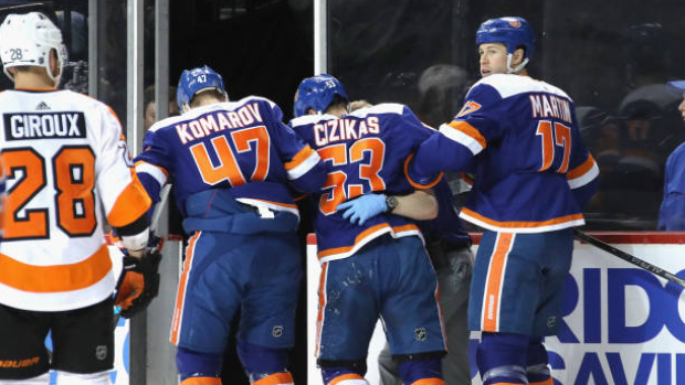 Islanders help injured Cizikas off the ice, Getty Images Islanders help injured Cizikas off the ice