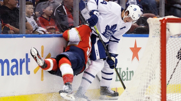 Leafs centre Auston Matthews slams Panthers defenceman MacKenzie Weegar into the boards.