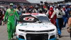 NASCAR drivers and crews as they push the car of Bubba Wallace to the front of the field