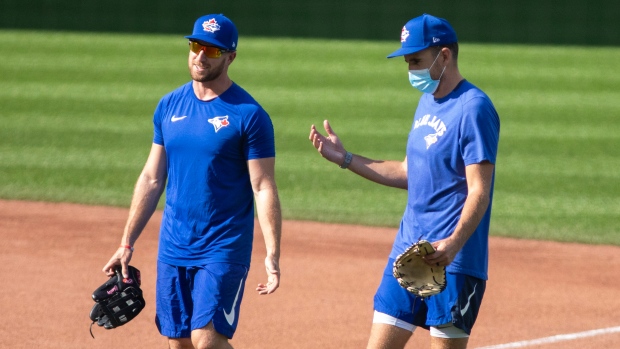 Toronto Blue Jays' Patrick Kivlehan and a staff member