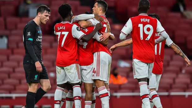 Arsenal players celebrate, The Canadian Press Arsenal players celebrate
