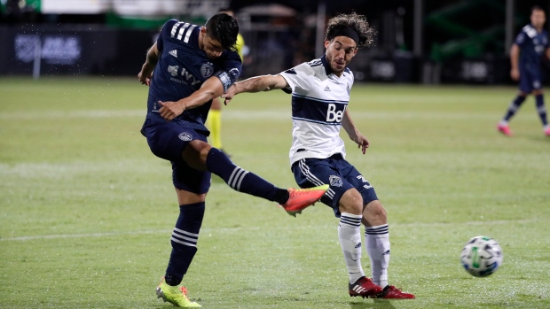 Sporting Kansas City forward Alan Pulido and Vancouver Whitecaps midfielder Russell Teibert, The Canadian Press Sporting Kansas City forward Alan Pulido and Vancouver Whitecaps midfielder Russell Teibert