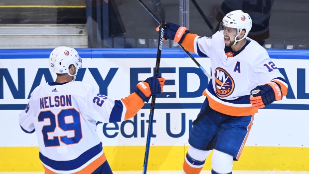  Josh Bailey (12) celebrates his goal with teammate Brock Nelson (29)