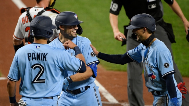 Randal Grichuk, center, with Joe Panik, left, and Cavan Biggio