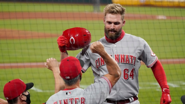 Cincinnati Reds' Matt Davidson (64) is congratulated by hitting coach Alan Zinter