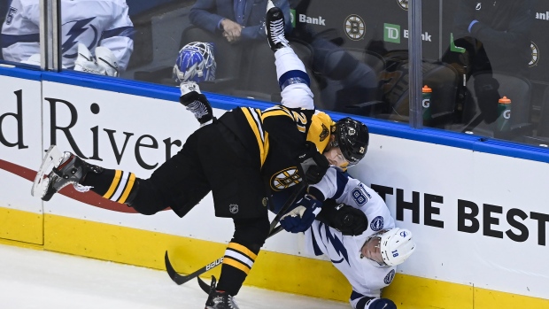Boston Bruins left wing Nick Ritchie (21) takes out Tampa Bay Lightning left wing Ondrej Palat