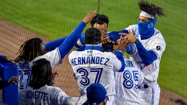 Alejandro Kirk and his Toronto Blue Jays teammates celebrate, The Canadian Press Alejandro Kirk and his Toronto Blue Jays teammates celebrate