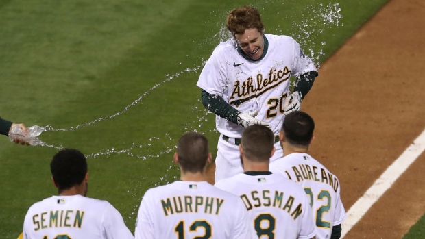 Mark Canha celebrates with Oakland Athletics