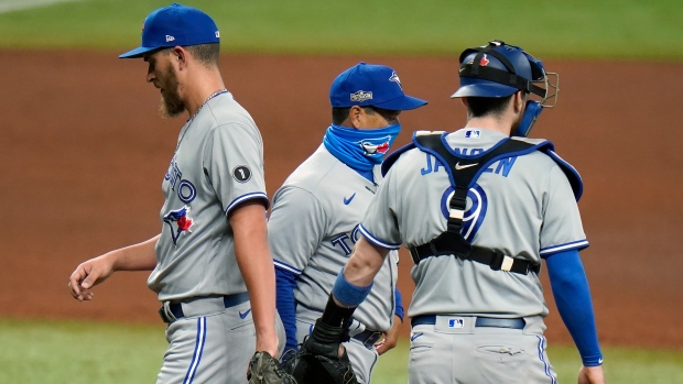 Blue Jays manager Charlie Montoya, center, takes relief pitcher A.J. Cole out against the Rays