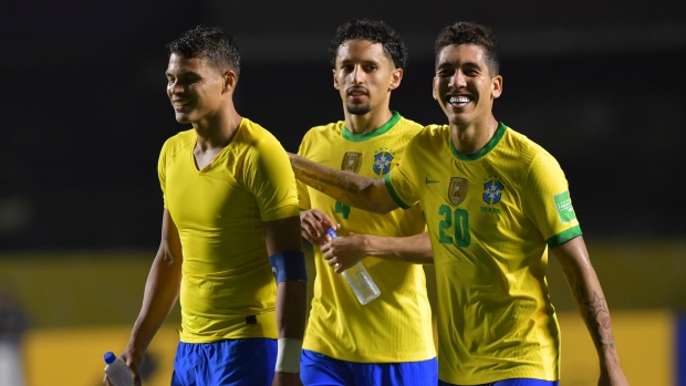 Brazil's Roberto Firmino, right, Marquinhos, center, and Thiago Silva celebrate