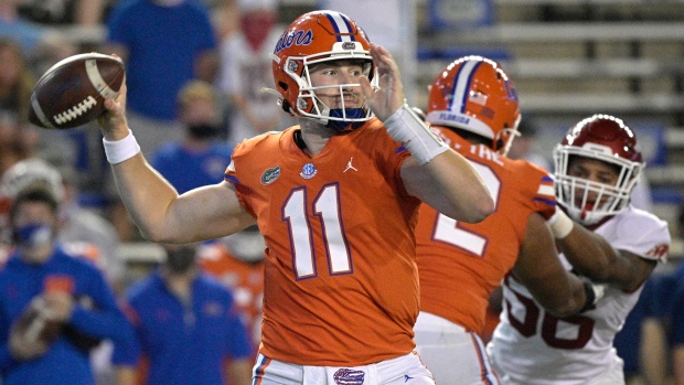 Florida's Kyle Trask (11) attempts a pass agaist Arkansas