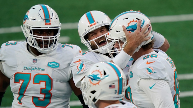 Miami Dolphins celebrate, The Canadian Press Miami Dolphins celebrate