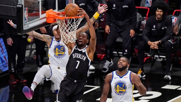 Brooklyn Nets' Kevin Durant (7) dunks on Golden State Warriors