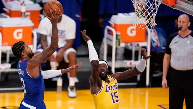 Los Angeles Clippers' Paul George shoots over Los Angeles Lakers' Montrezl Harrell